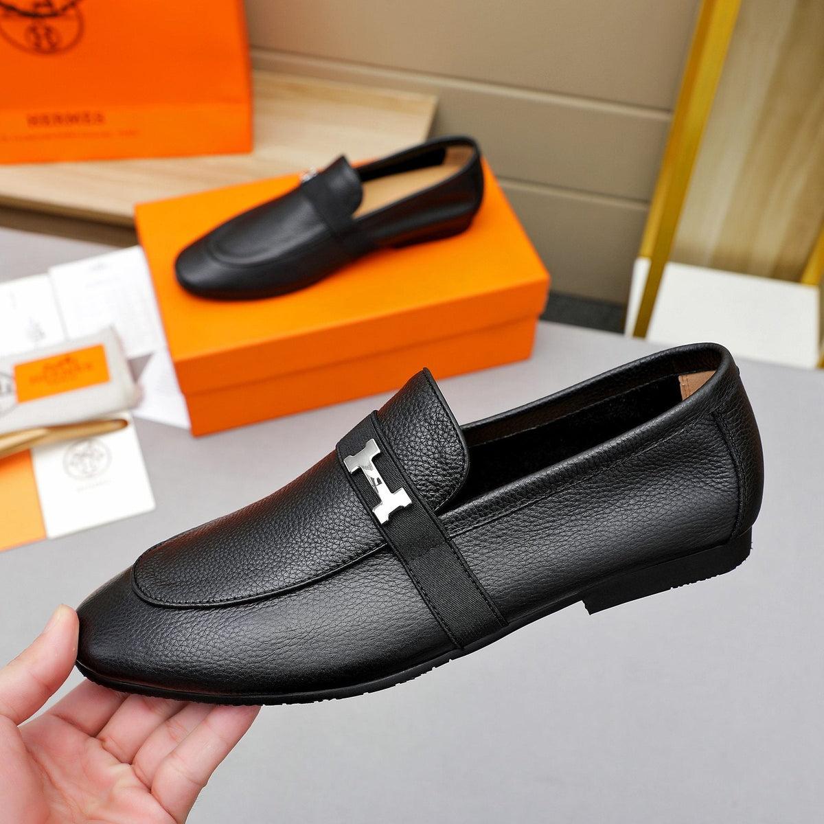 Hermès Black Pebbled Leather H-Hardware Loafers — side